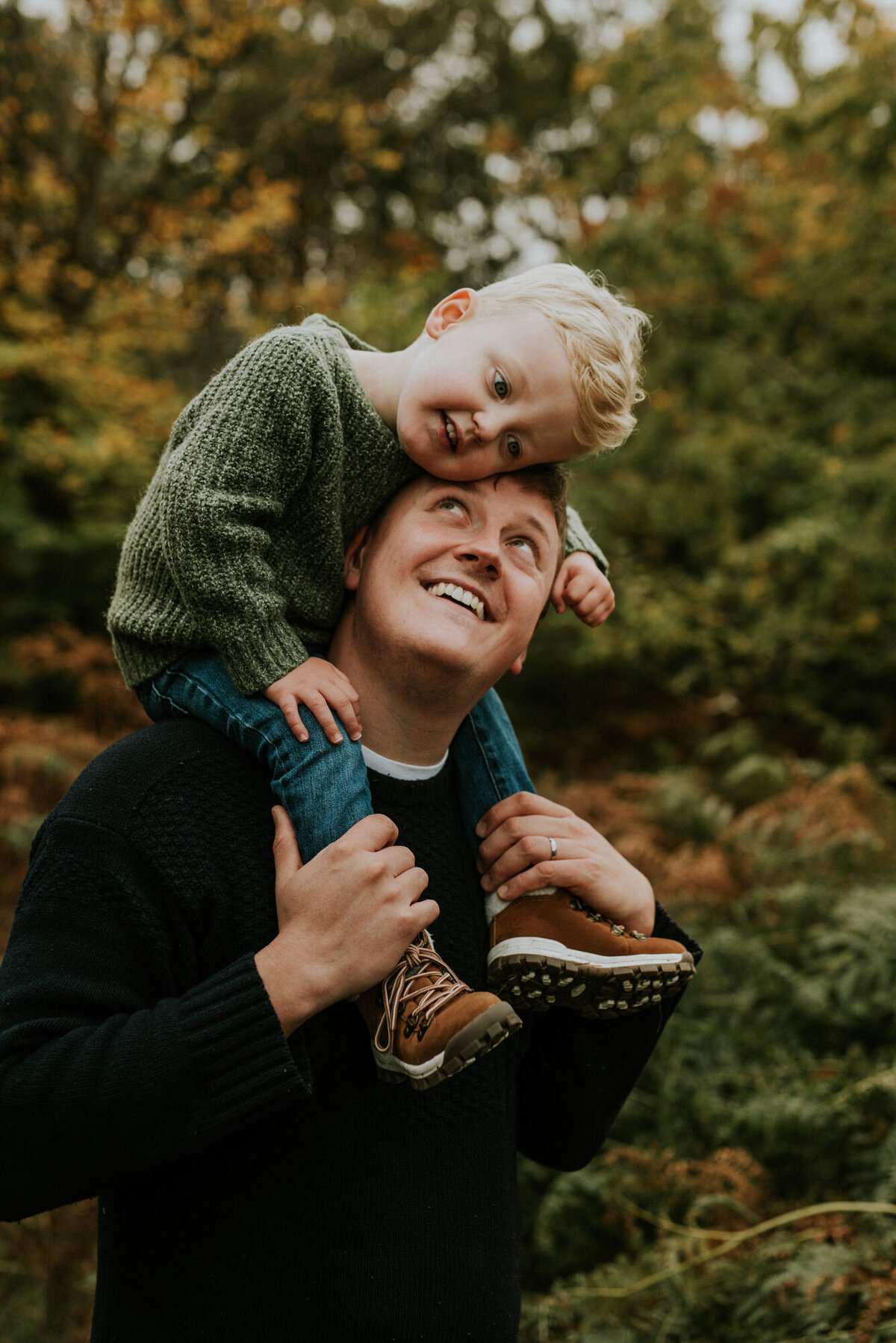 Father giving young son ride on shoulders