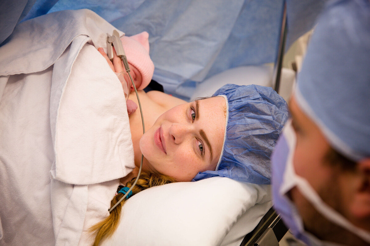 C-section at Victoria Hospital in London, Ontario (LHSC). Mother is holding newborn baby while still in OR.