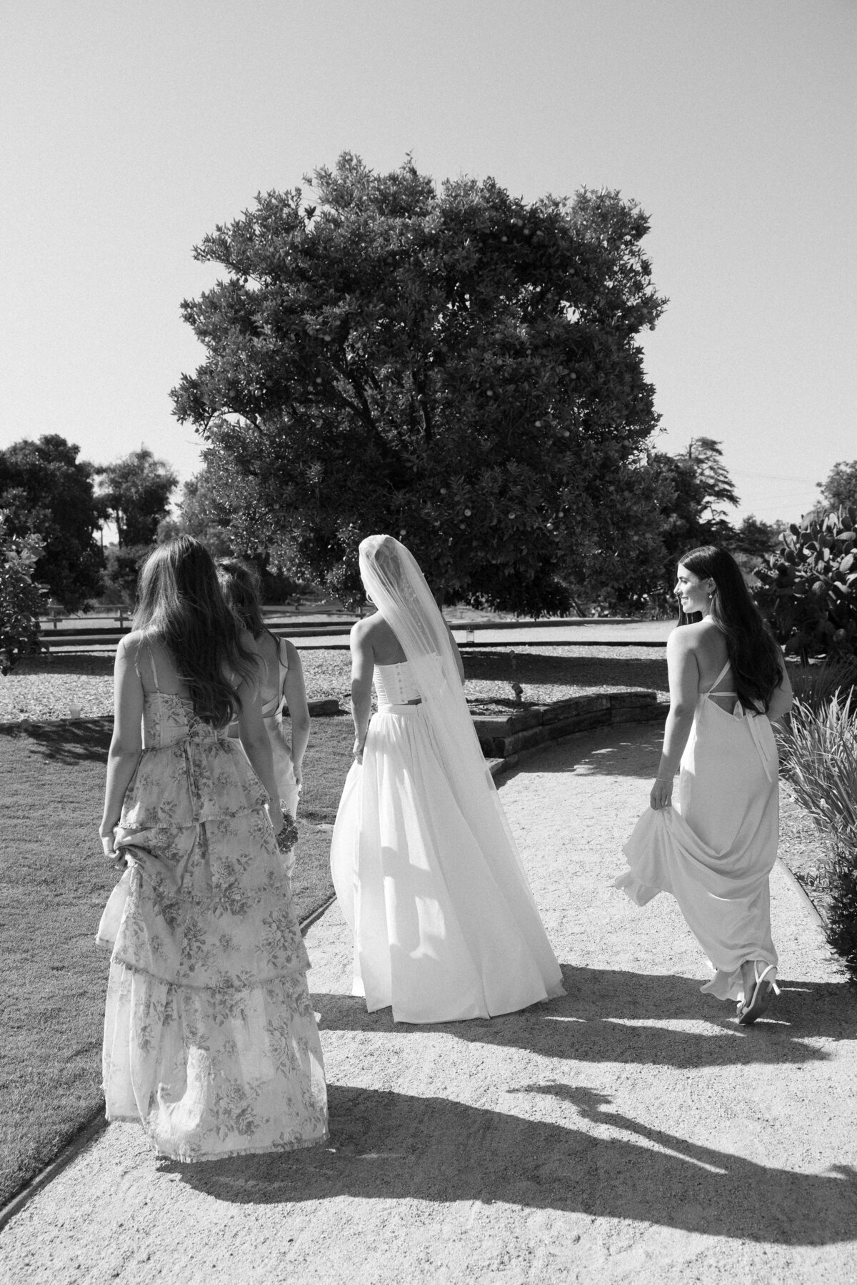 Candid moment of the bride laughing with her bridesmaids during preparations, capturing the excitement of the day in La Jolla in San Diego, California.