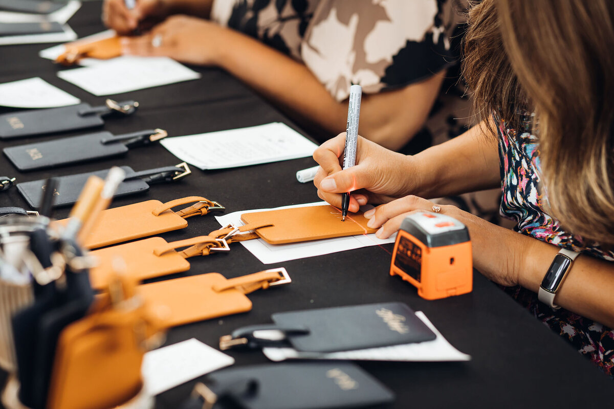 Hand lettering on leather luggage tags for a brand activation