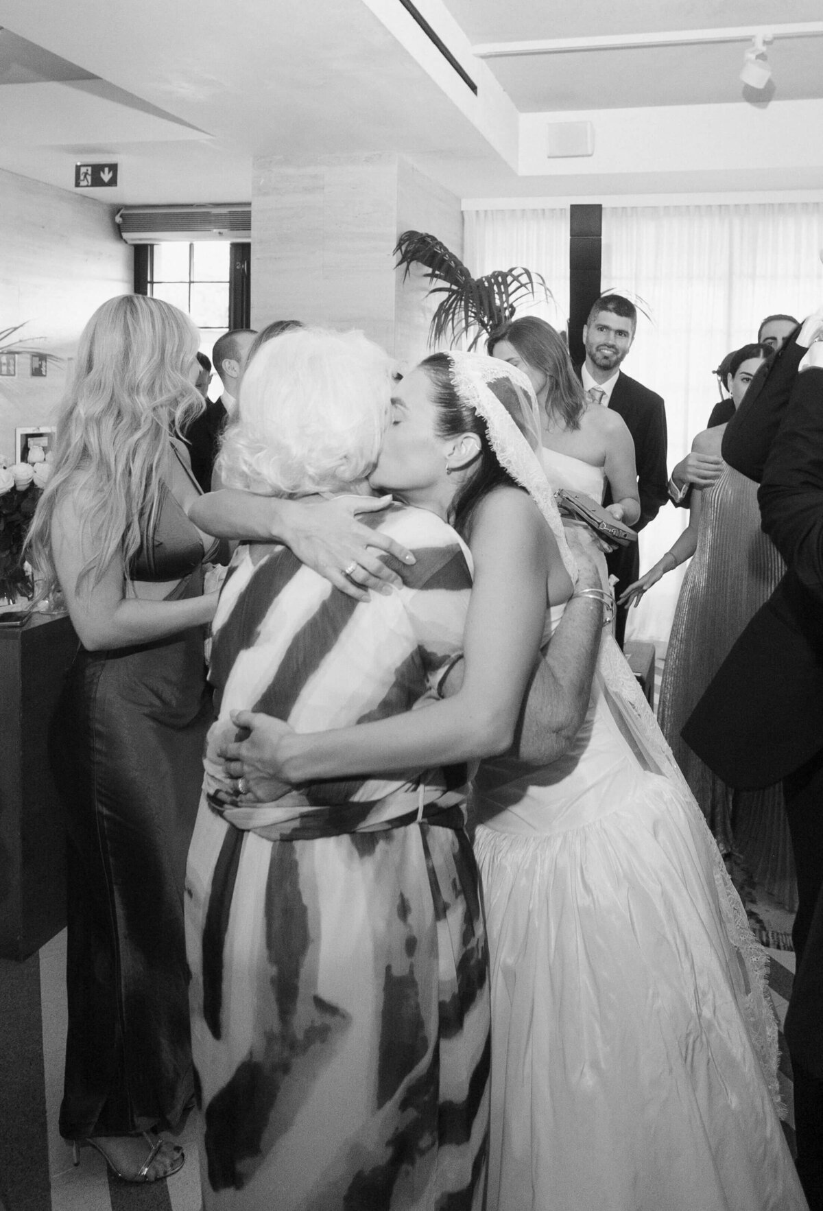 Bride hugging guest during reception at Soho House Rome

