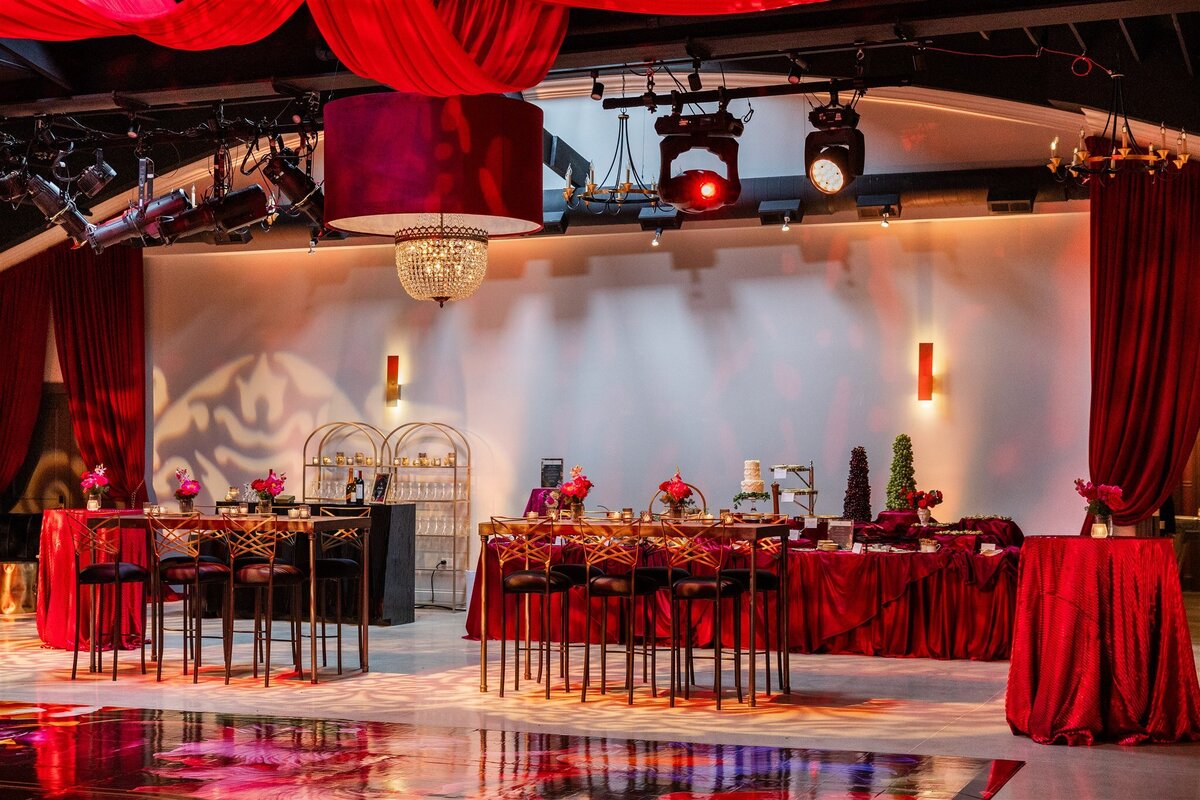 Event space styled with a Baroque theme, featuring ornate gold accents, rich fabrics, grand chandeliers, and intricate moldings, creating a luxurious and dramatic atmosphere