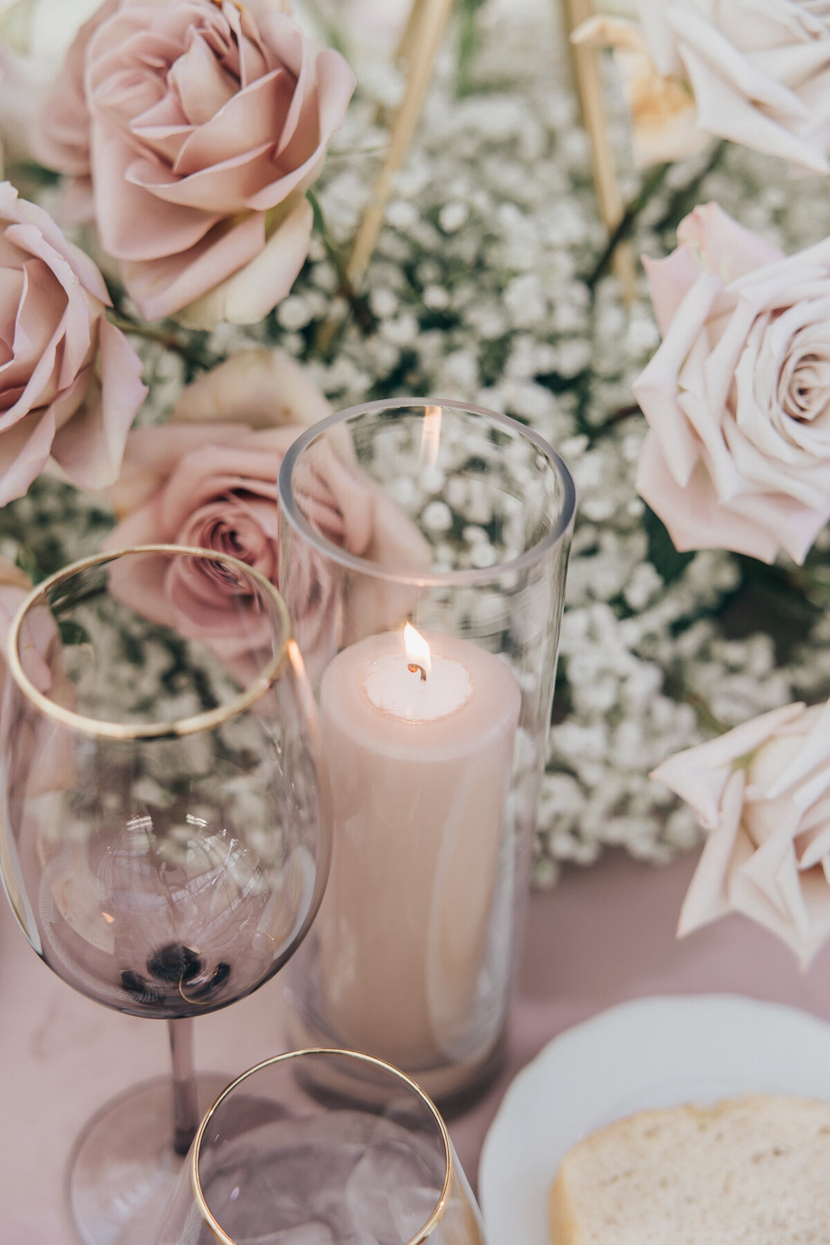 Beautiful candles, roses, and baby's breath at lavender and ivory themed wedding reception