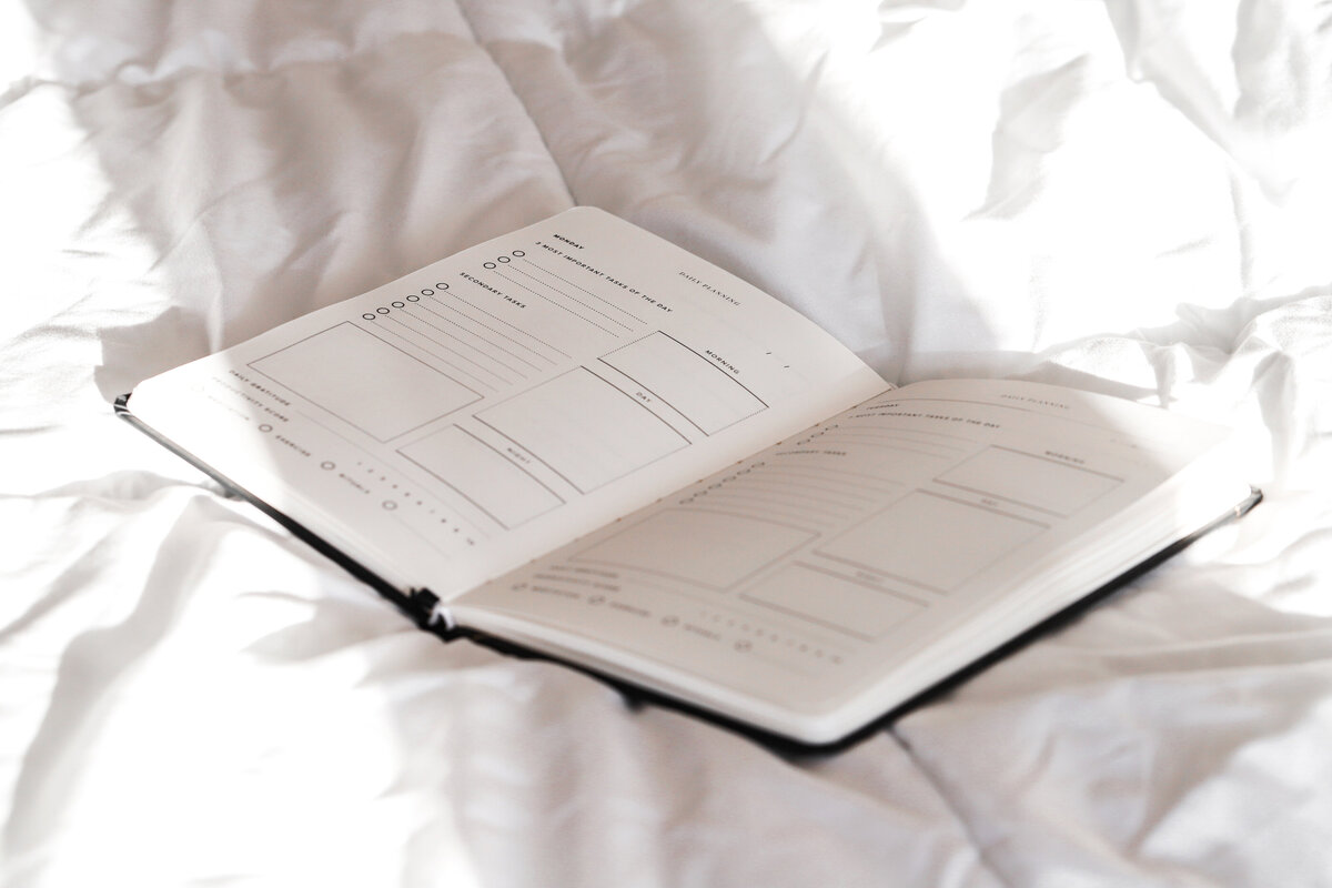 an image of a planner on a website for coaching for moms in Matrescence, called 'Reclaimed'.