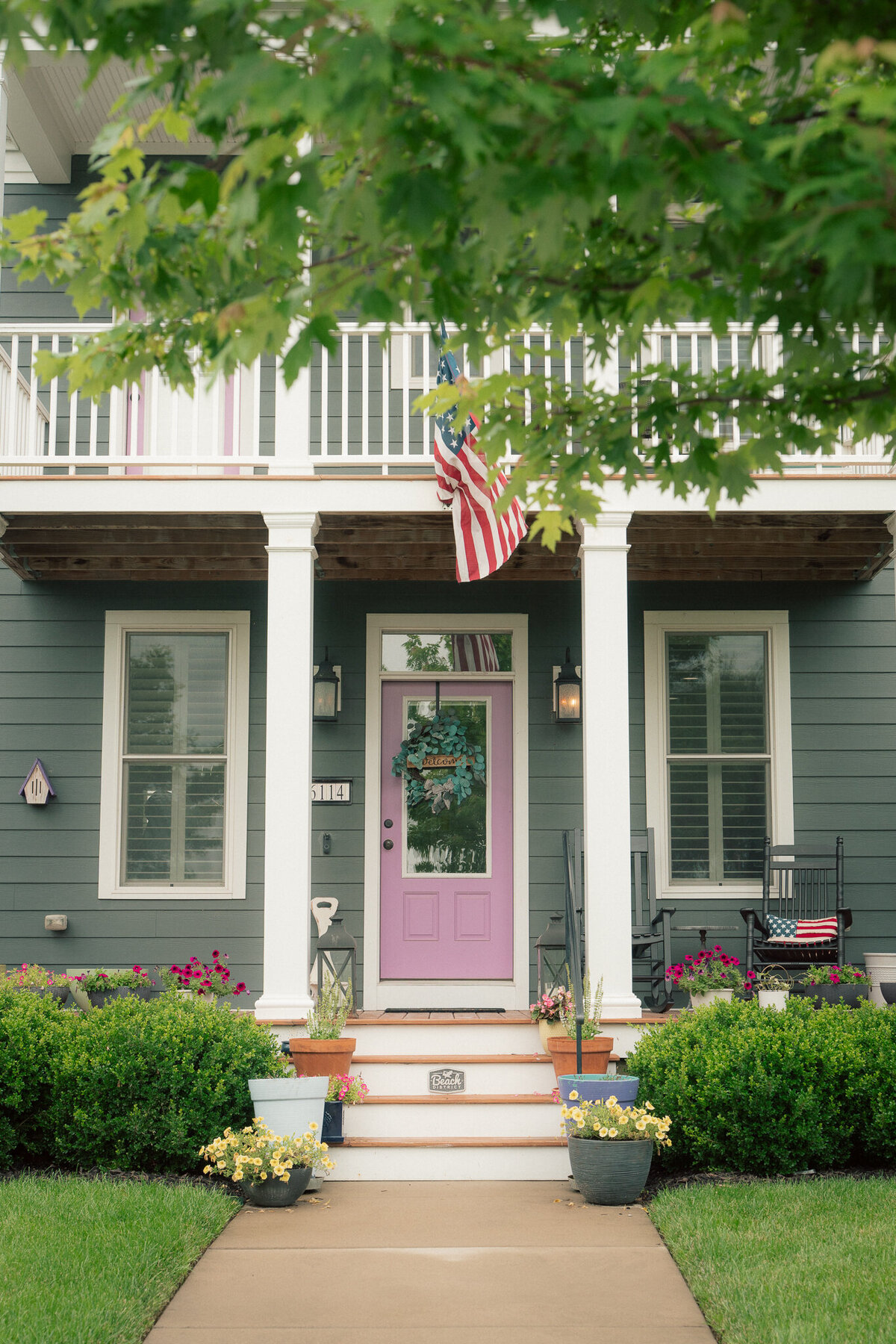 Charming front porch with pink door and American flag in St. Charles wedding