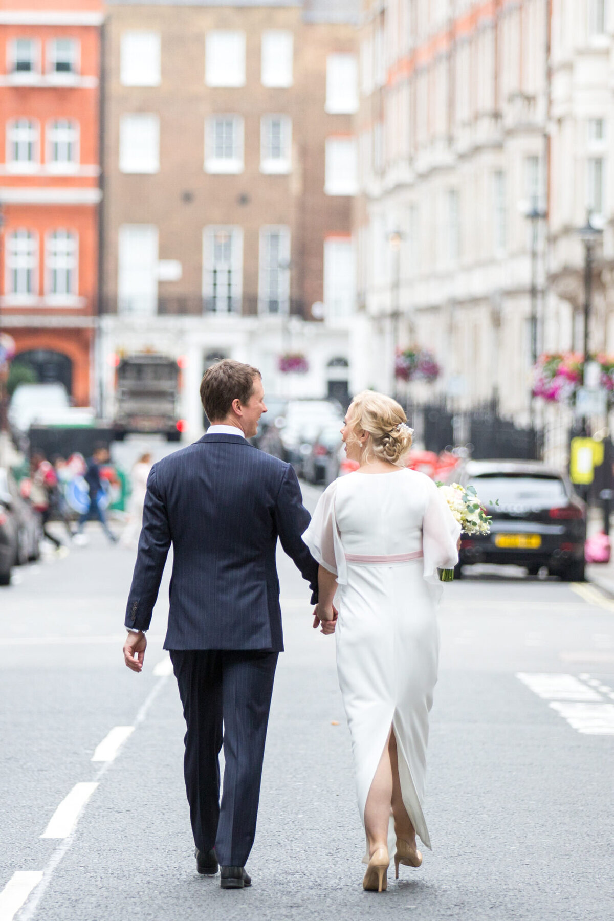 Bride and Groom walking through London Streets