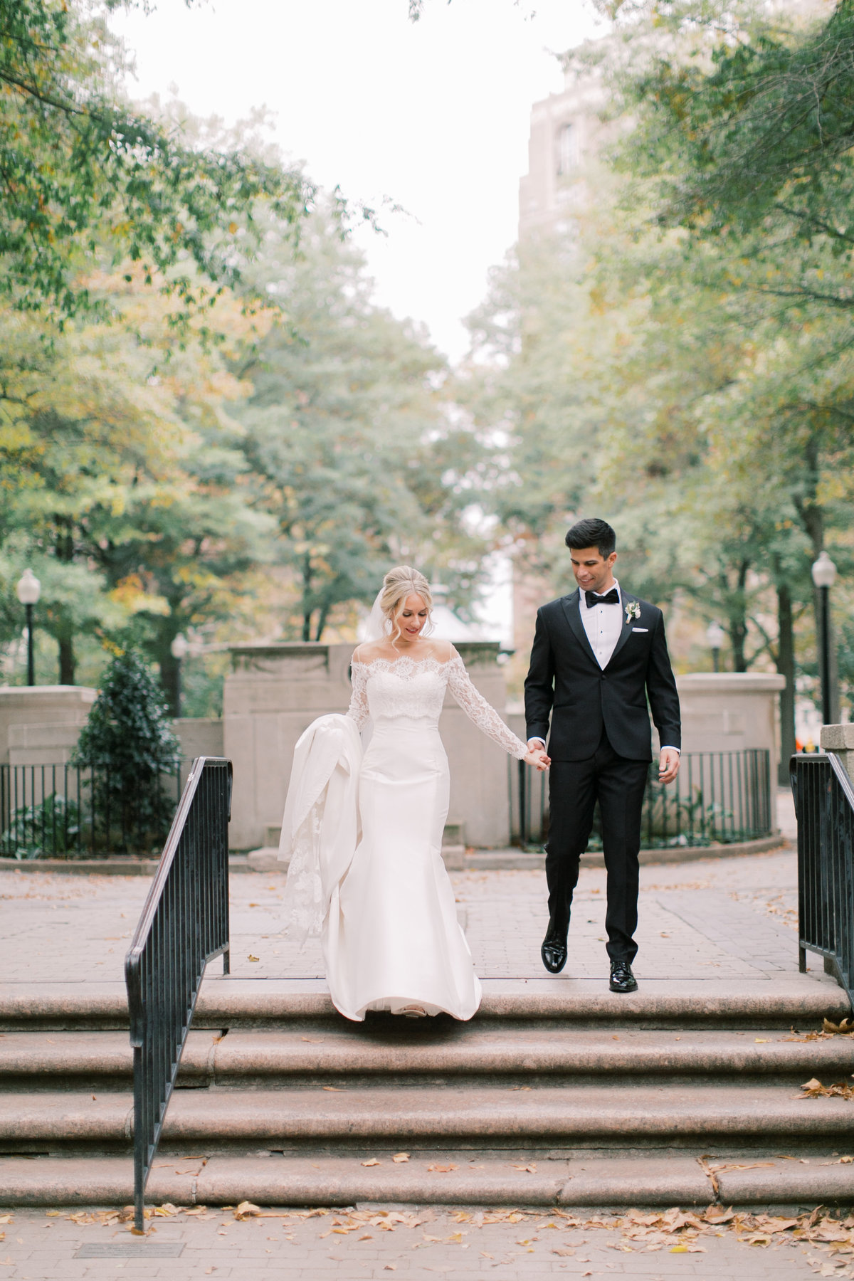 bride and groom walking down steps at Philadelphia wedding