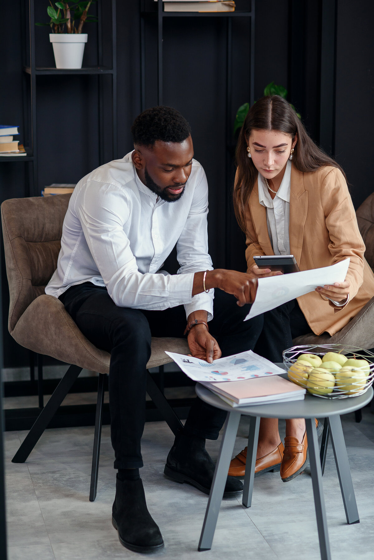 Two business partners reviewing documents together