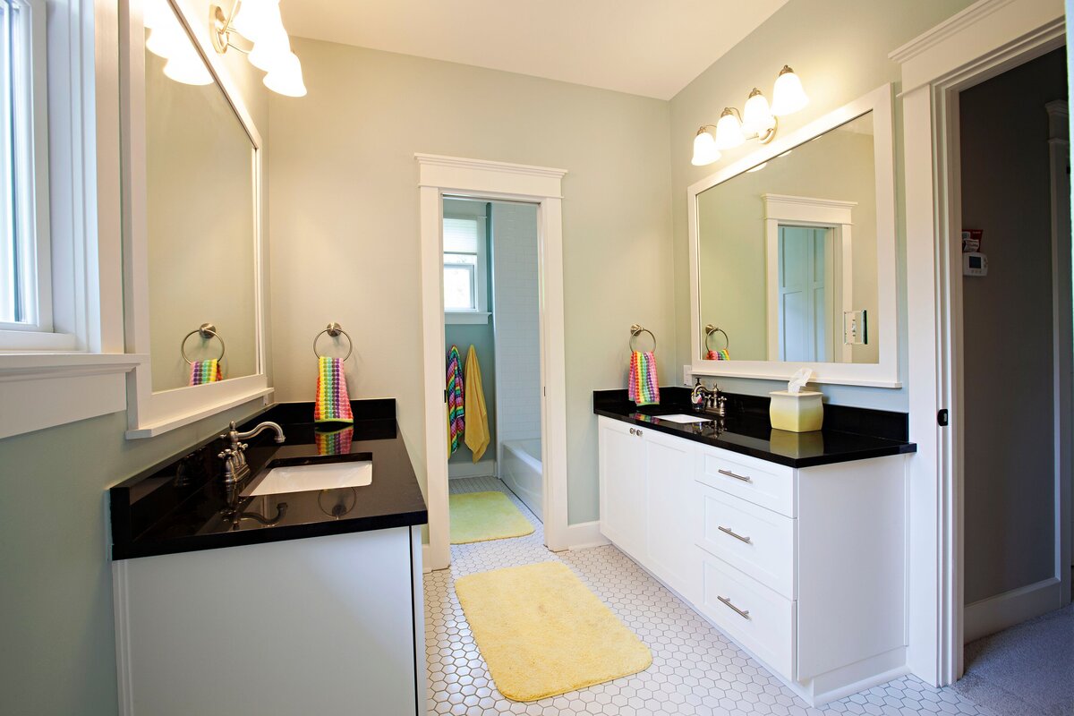 double, mirroring sinks in bathroom. Large bathroom mirrors and walk-in shower.