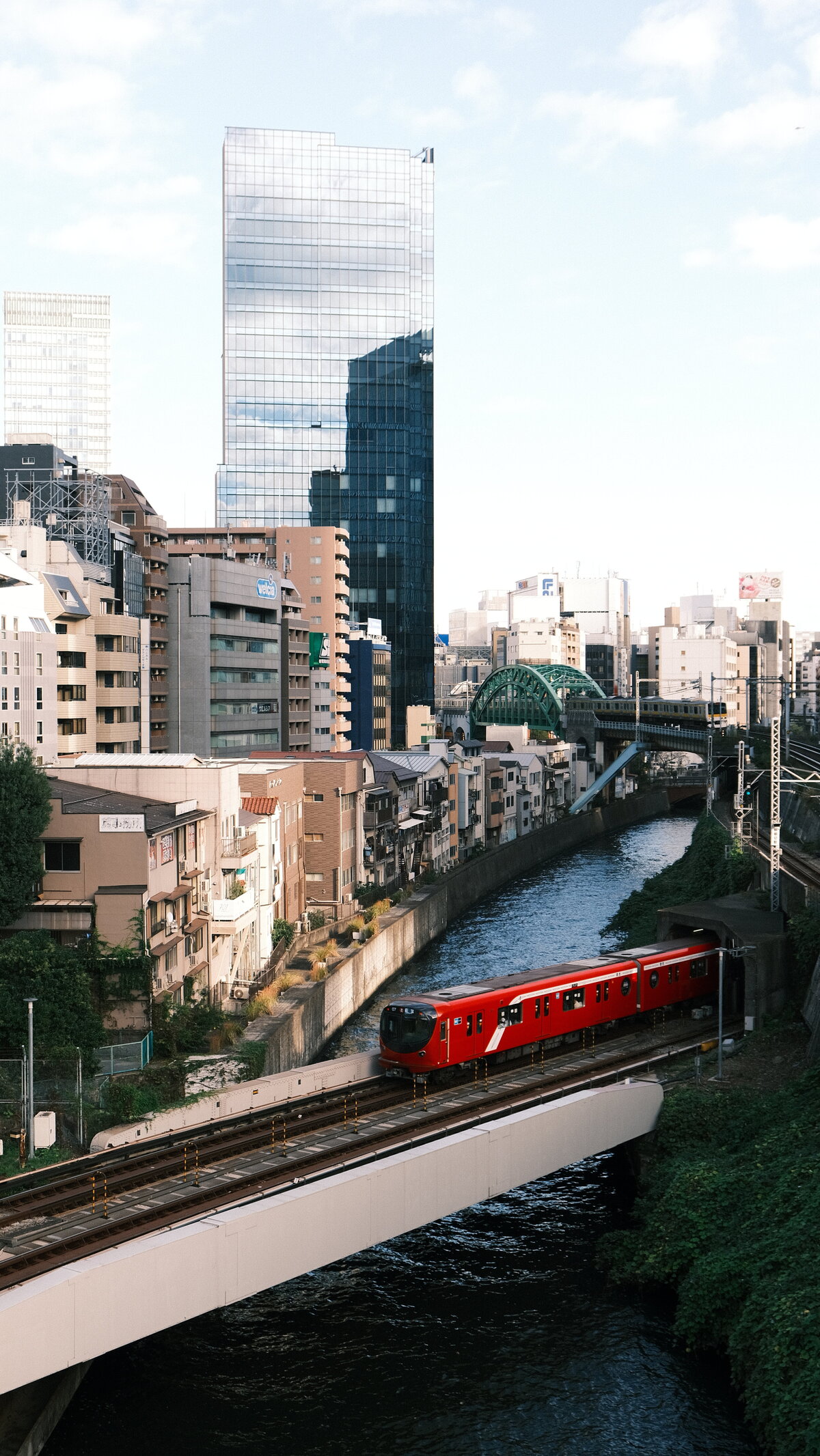 A red train crosses over a river in Tokyo, Japan.