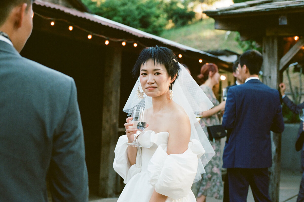 A bride looks at photographer on her wedding day in Los Gatos, CA