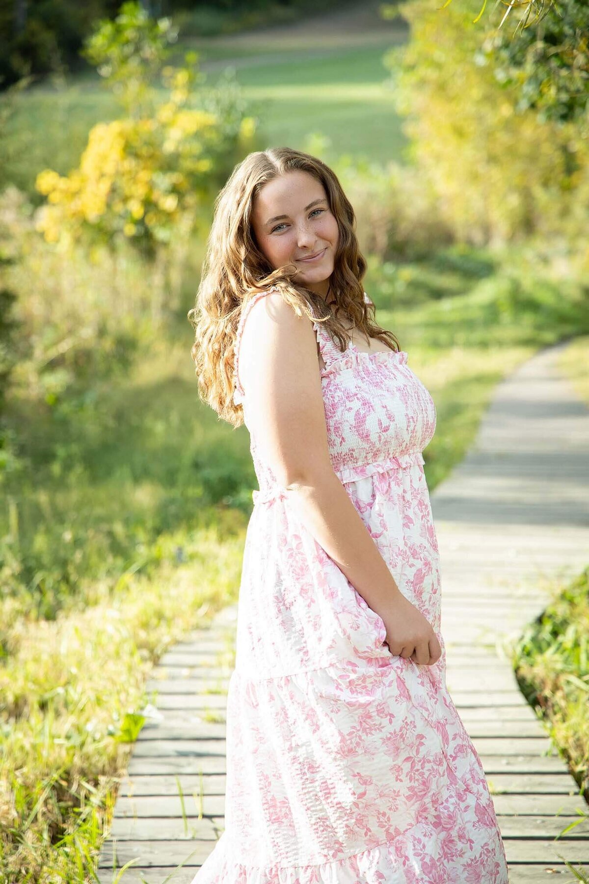 cute-senior-girl-in-pink-dress-at-sunset