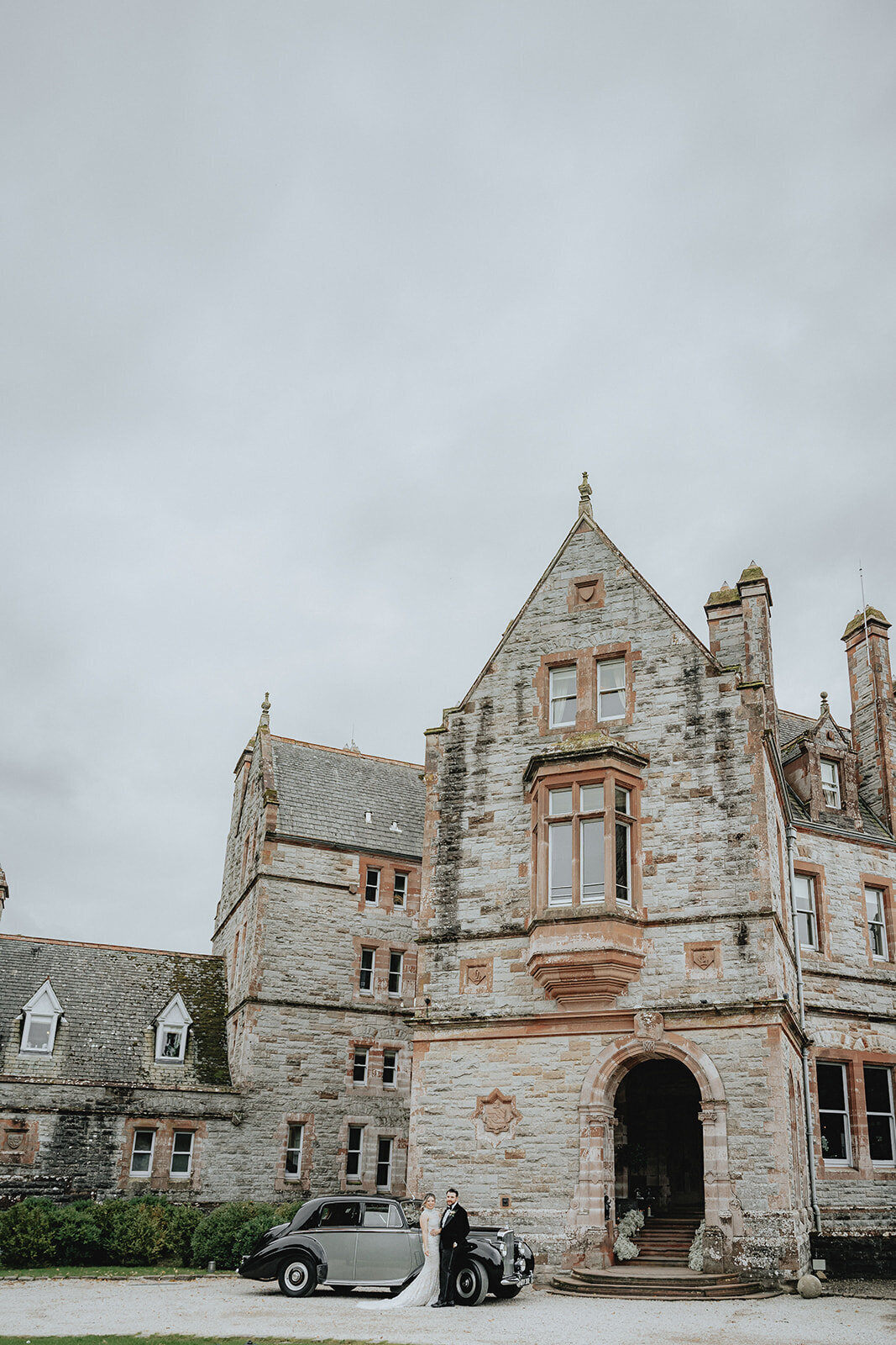 Bride and groom in front of the Castle in Leslie, Ireland
