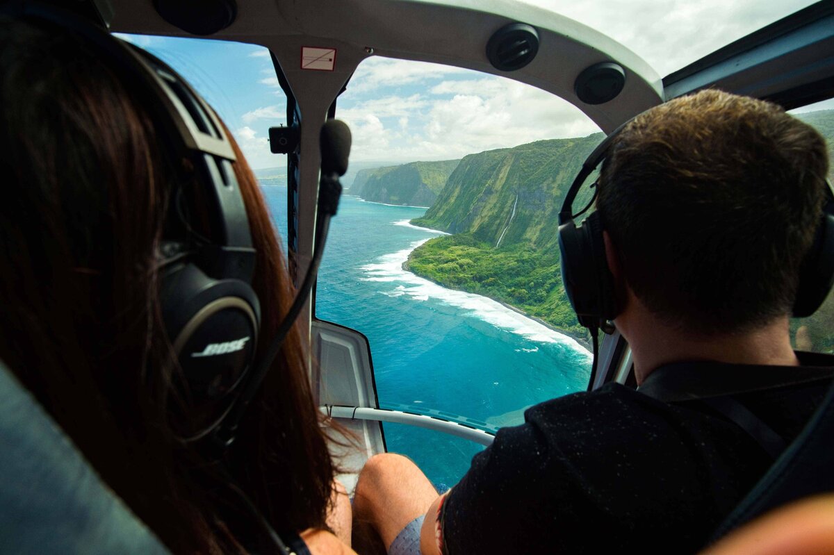 Helicopter Tour of the Big Island makes shows lush cliff and blue water below. Unique group activities and experiences for destination events.