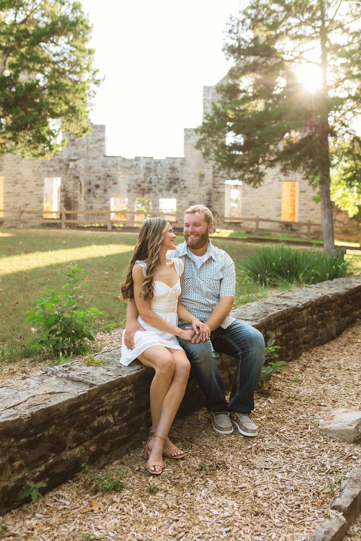 Couple holding hands at Ha Ha Tonks castle ruins in Missouri