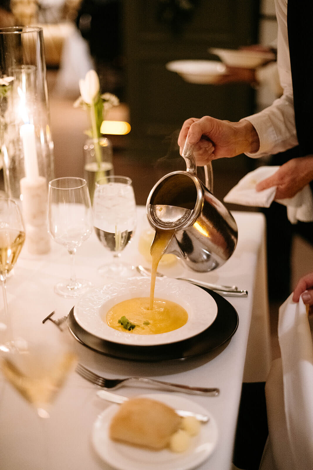 Dinner being served at the St. Regis Aspen wedding reception featuring a delicious soup course.