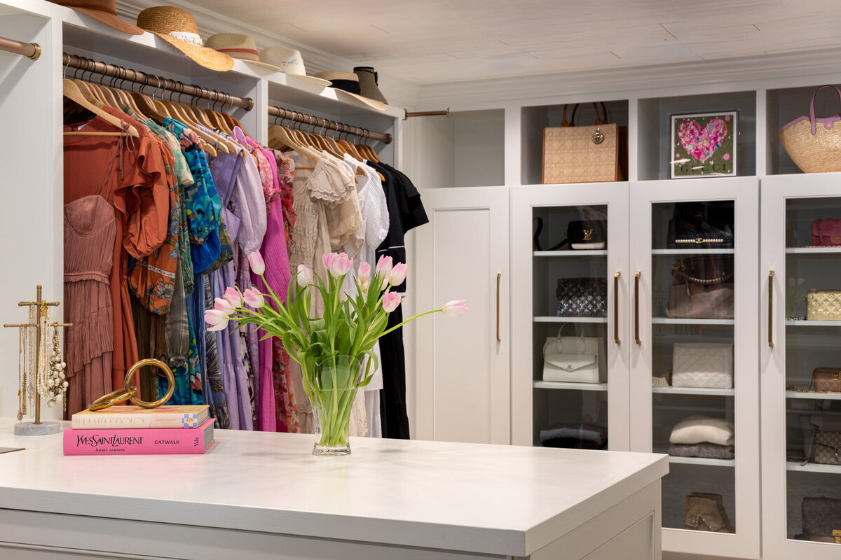 Custom closet design with cabinets and shelves. 