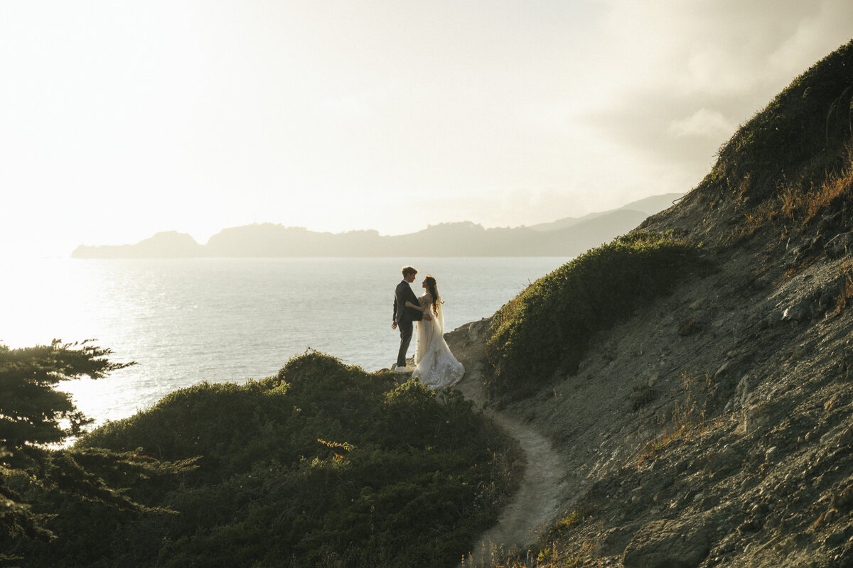 Bride and Groom at Marshall's Beach in San Francisco, California at sunset