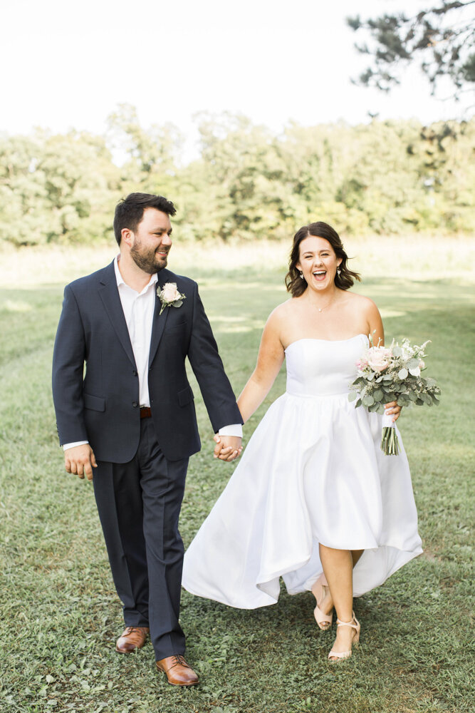 bride and groom walking together, laughing