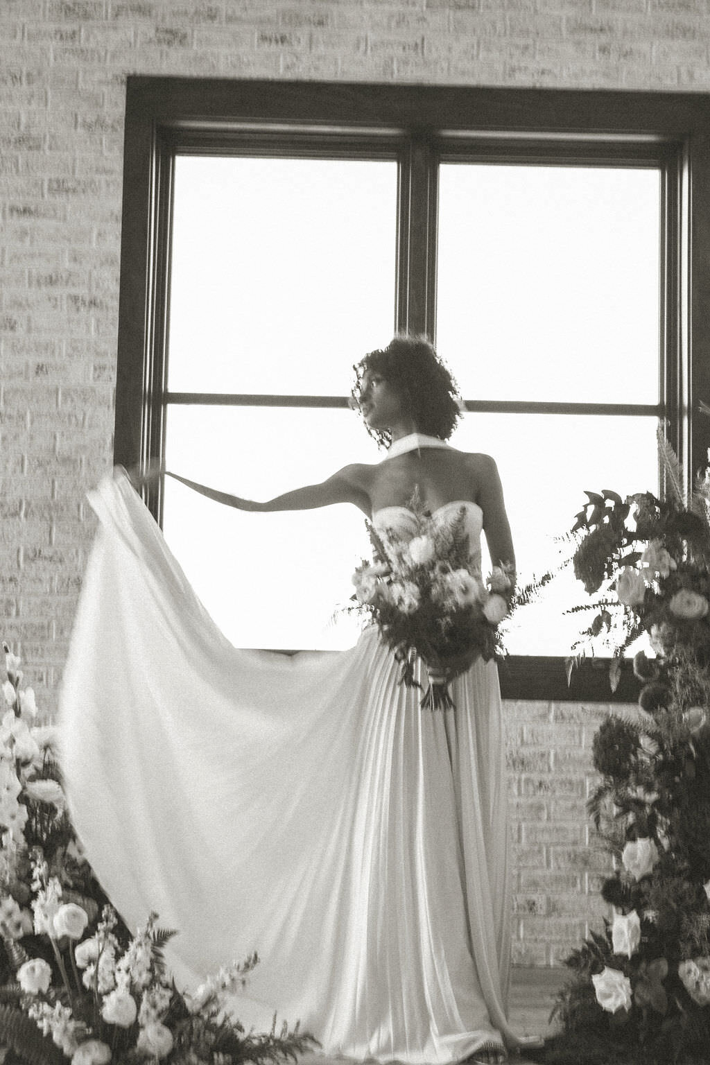 A person holding up the end of their wedding dress.