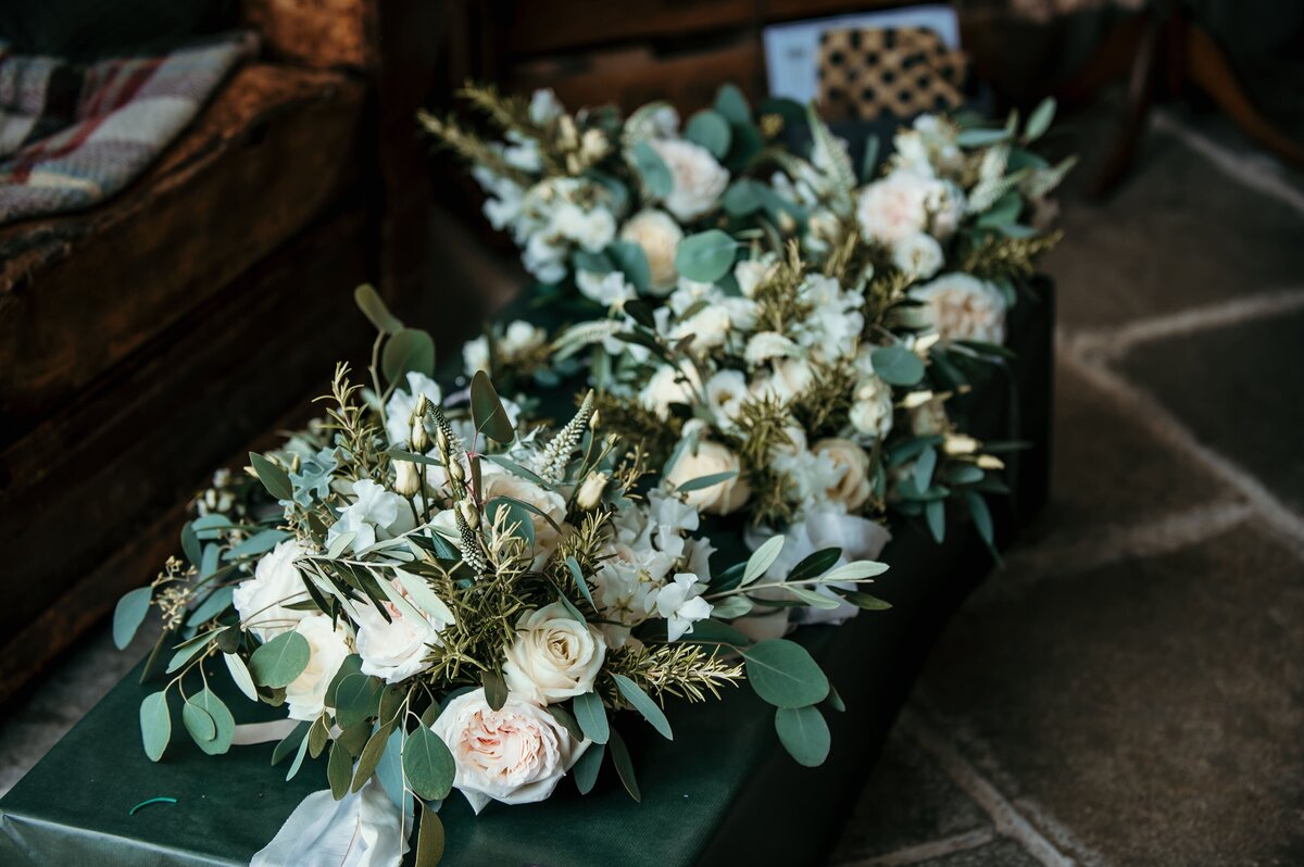 Bouquets of blush and pink roses for their wedding at Nancarrow Farm