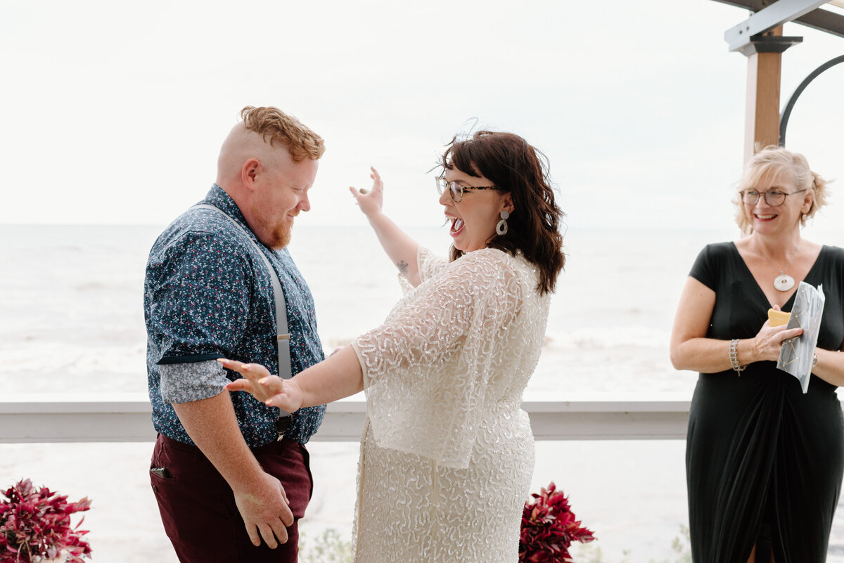 lake erie elopement bride and groom celebrate first kiss
