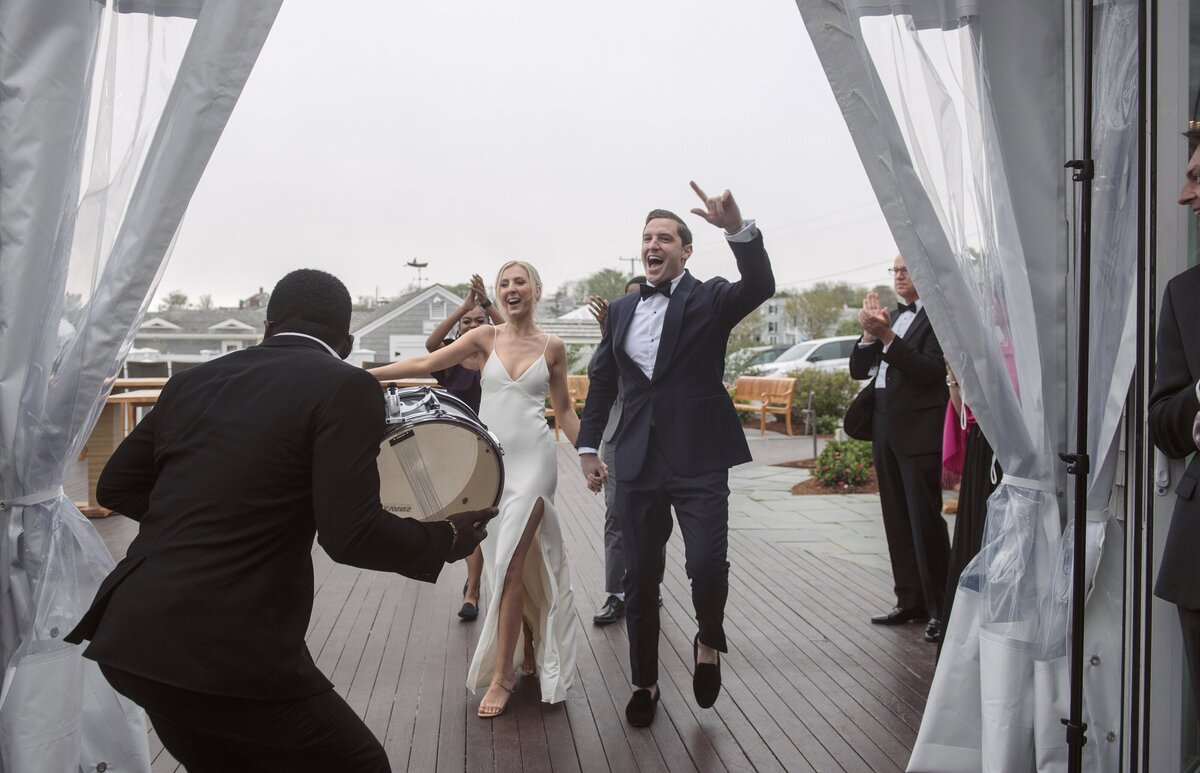 Couple celebrate as they are announced into reception at Chatham Bars Inn.