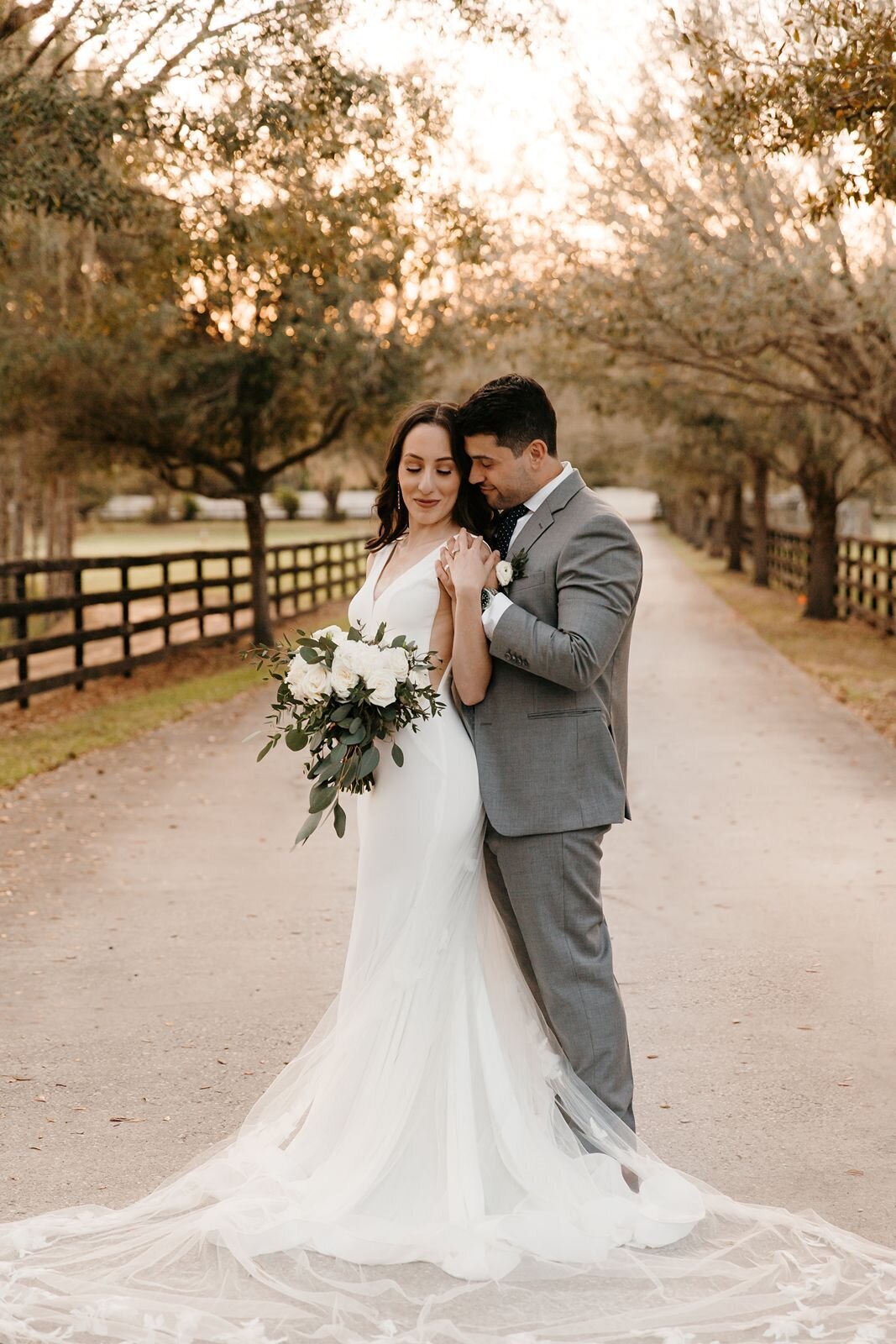 Bride and groom with trees at Club Lake Plantation in Apopka, Fl