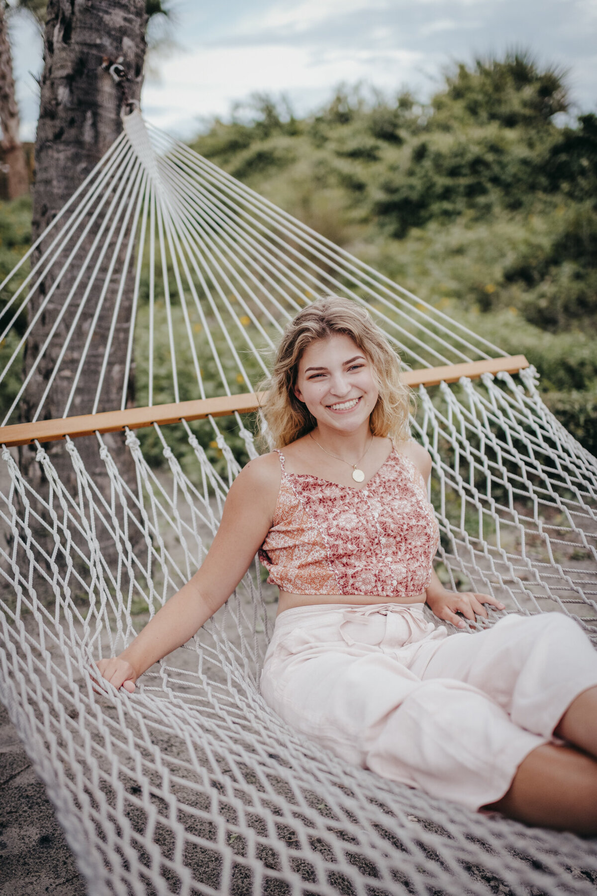 girl sitting on hammock at low country portrait session