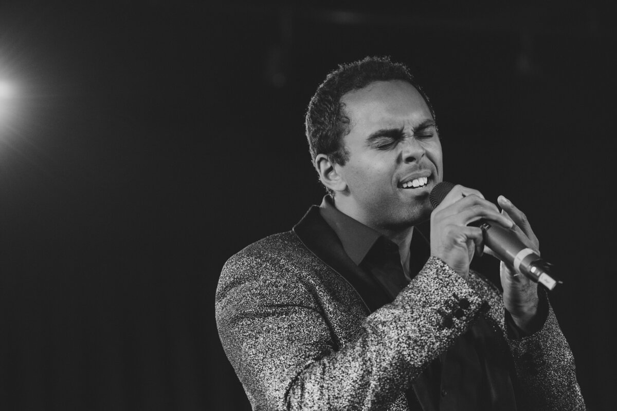 Black and white photo of a man singing