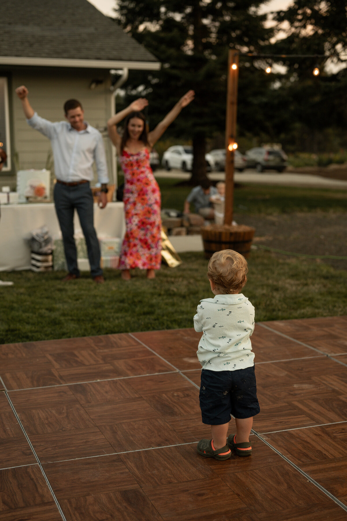 Mom and dad dancing with little boy at Idaho wedding taken by wedding photographers in Idaho