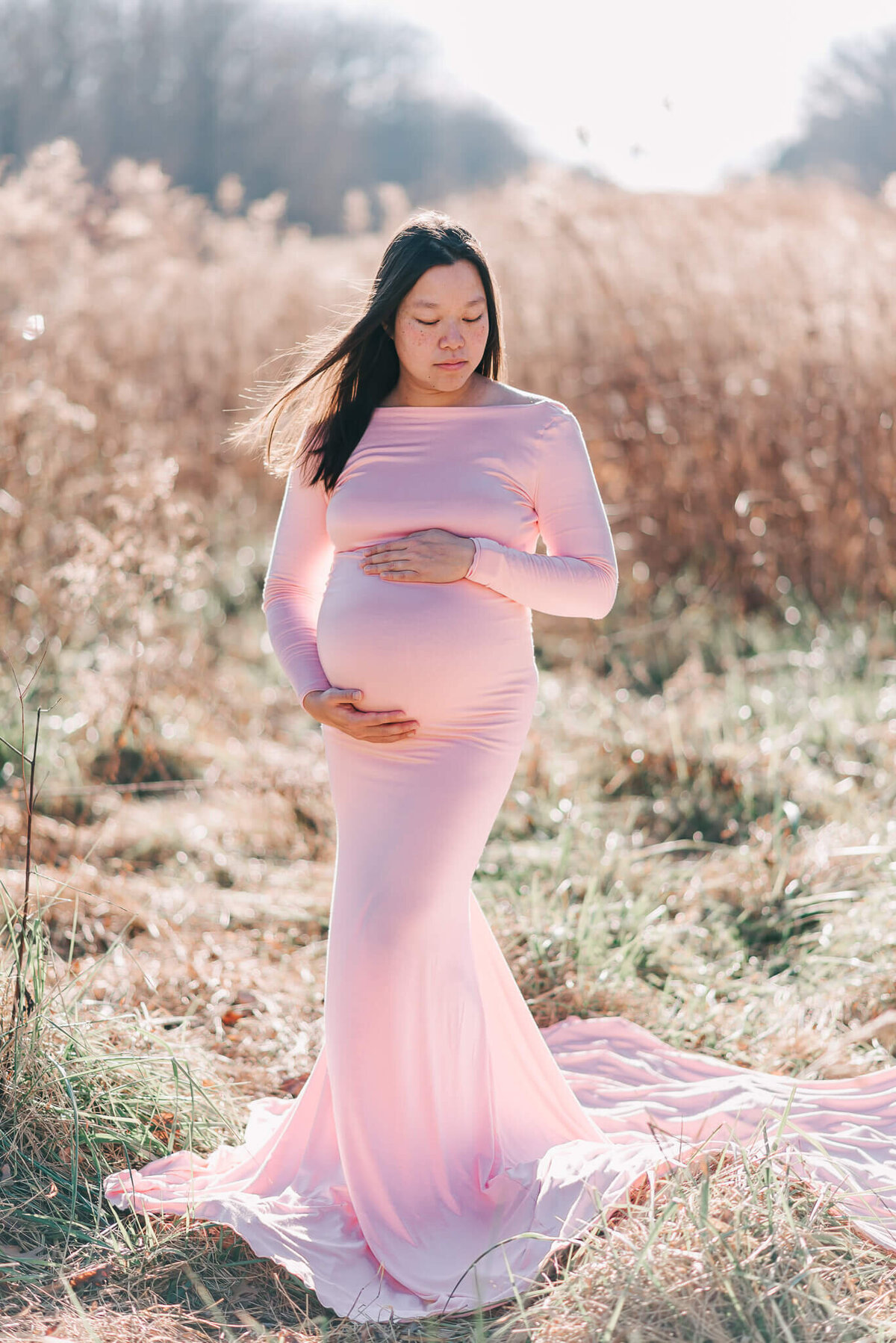 A resplendent pregnant mother rocking a pink SewTrendy maternity gown in Northern Virginia