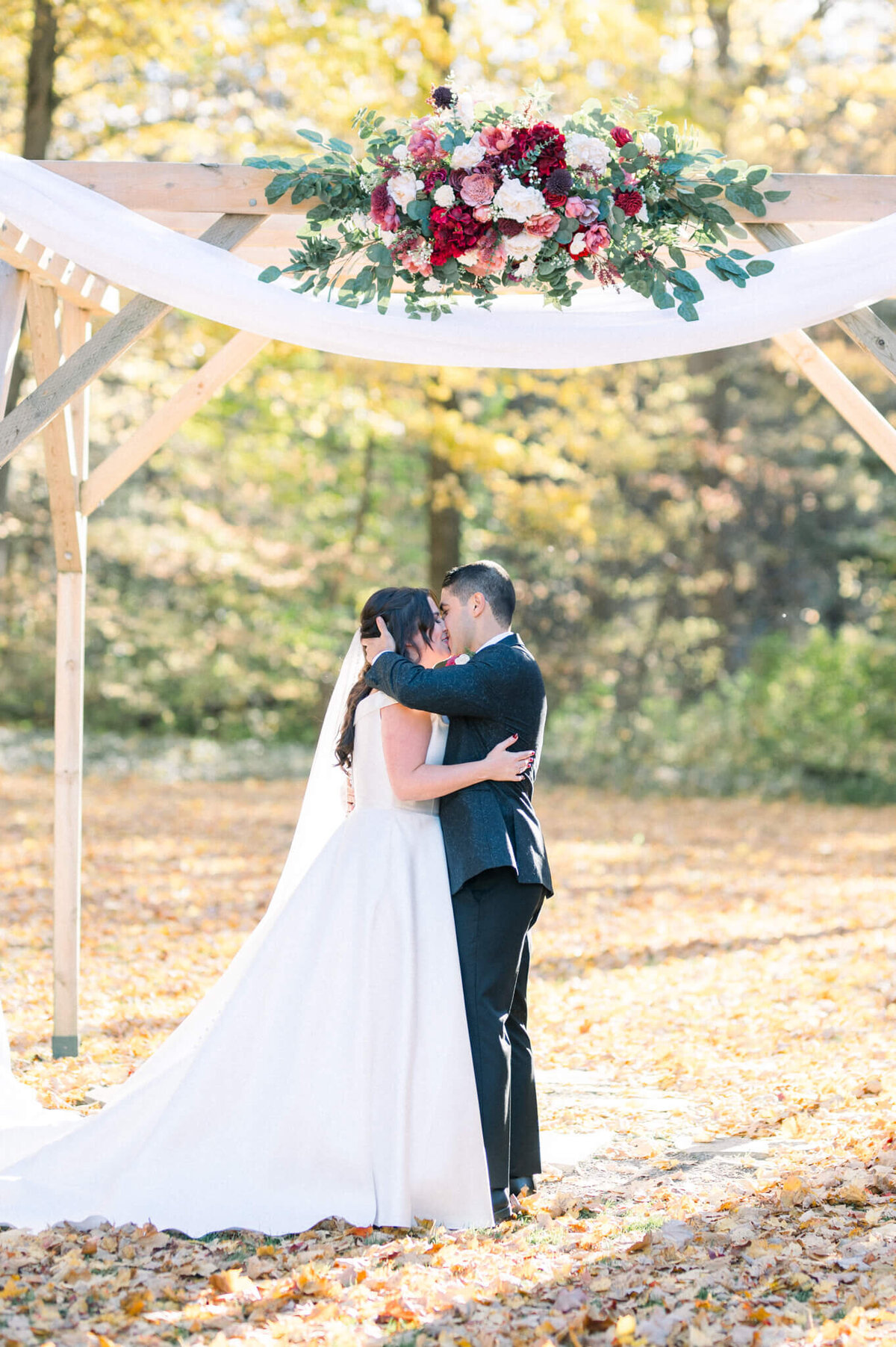 Bride and grooms first kiss under the arches at their Balls Fall's wedding. Captured by Niagara wedding photographer Kristine Marie Photography