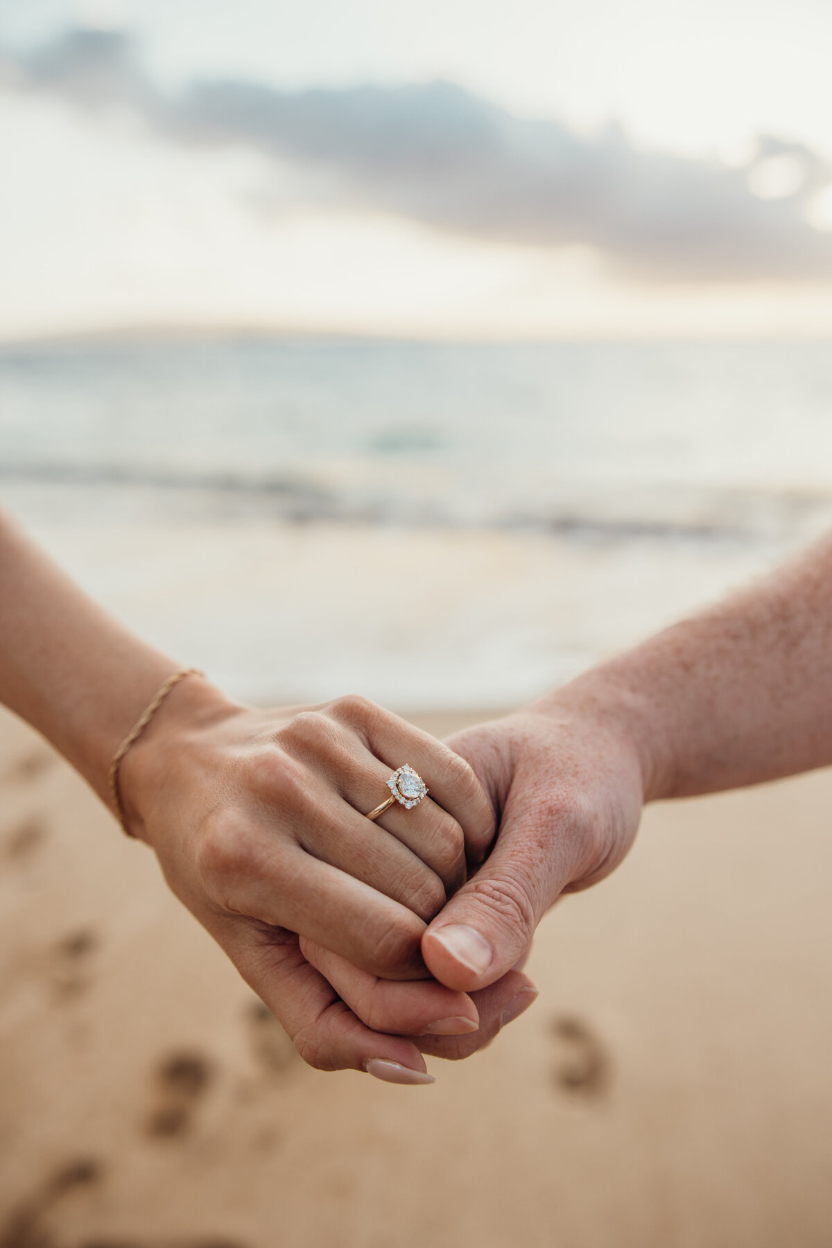 Hawaii Engagement Photographer captures engagement ring on woman's finger after beach proposal