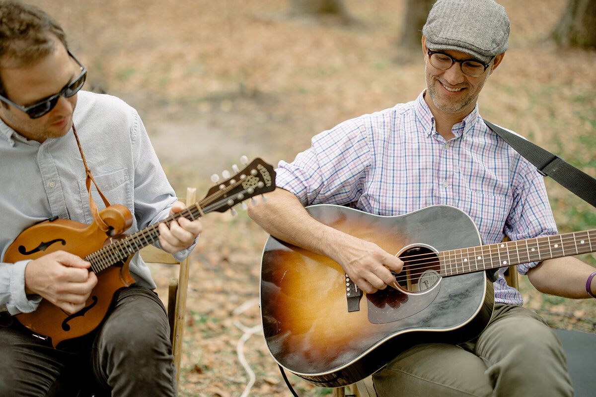 Two men playing guitar for a wedding