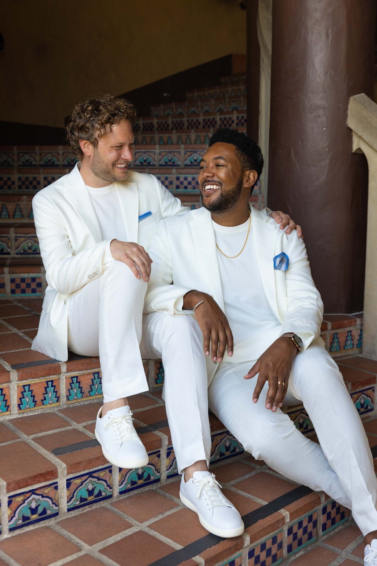 A couple sitting on a staircase together.