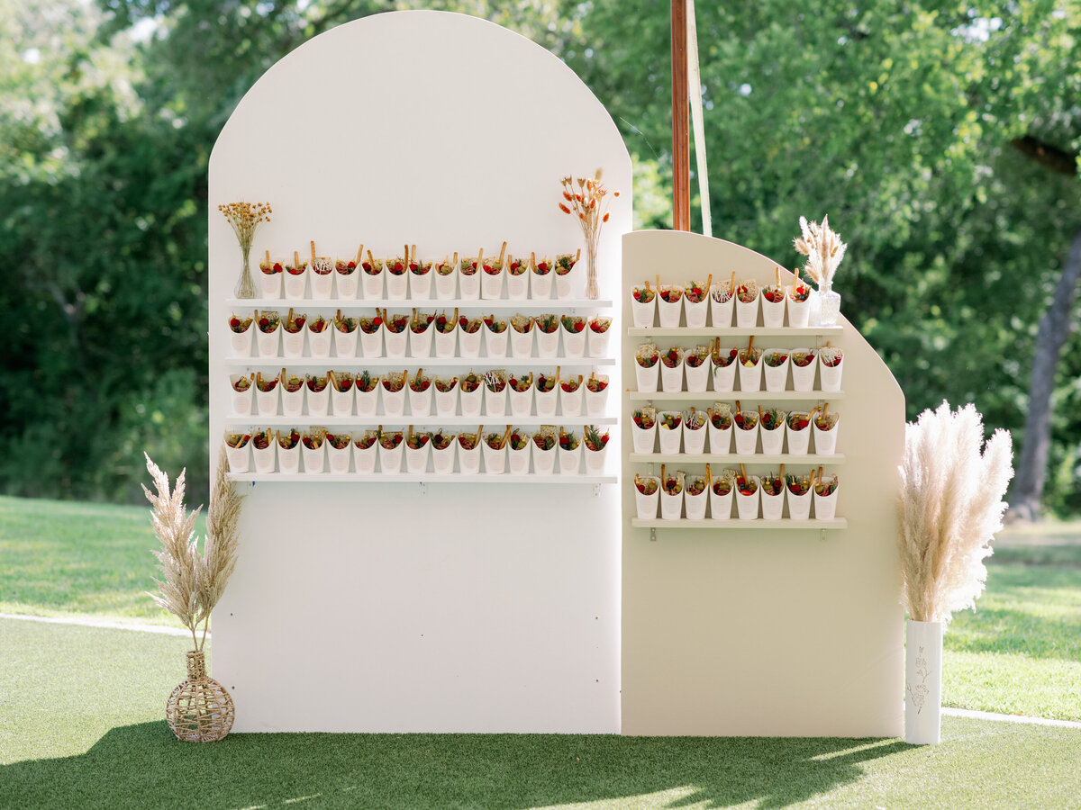 Neutral colored party favors arch backdrop display
