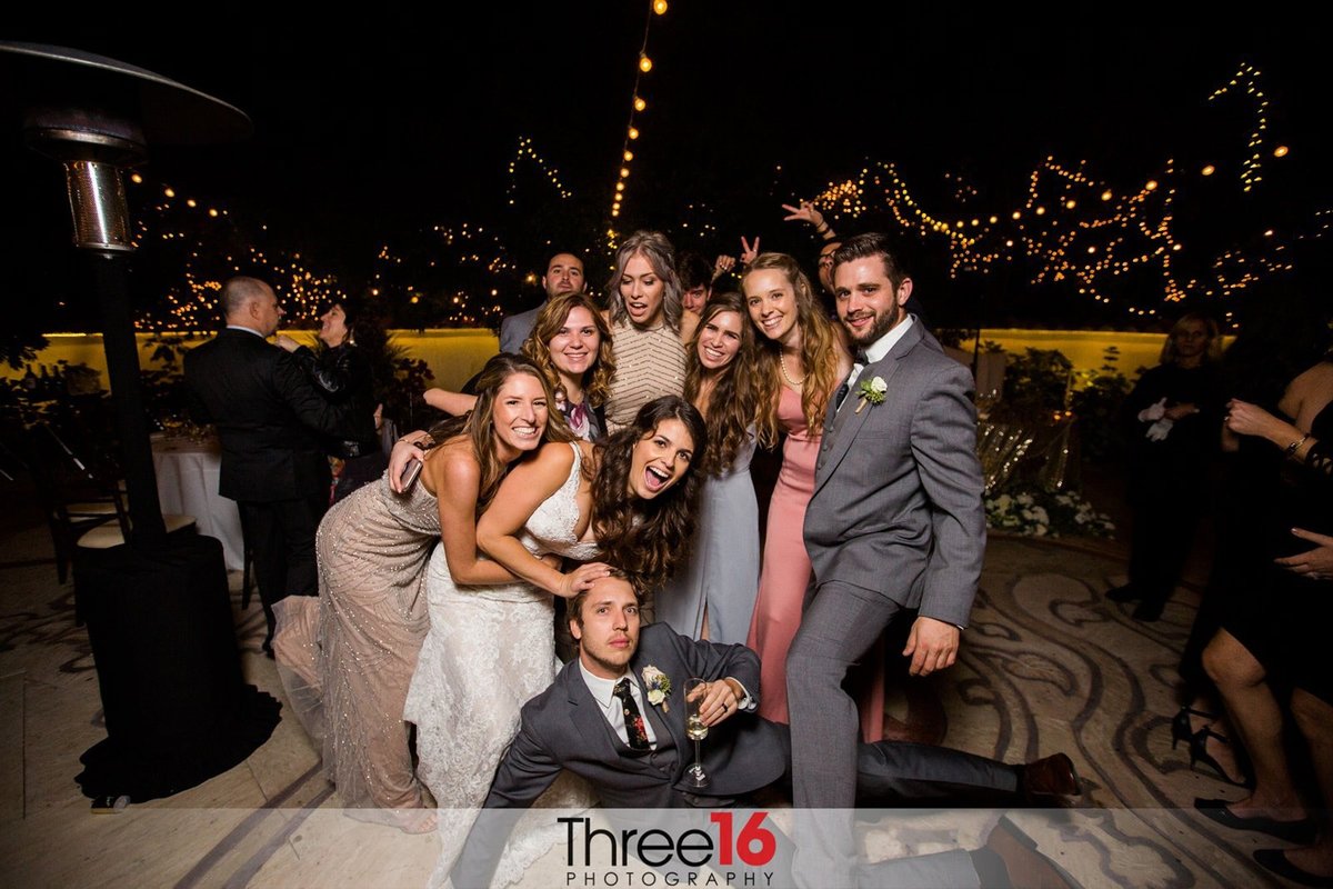 Group posing for photos at a wedding reception