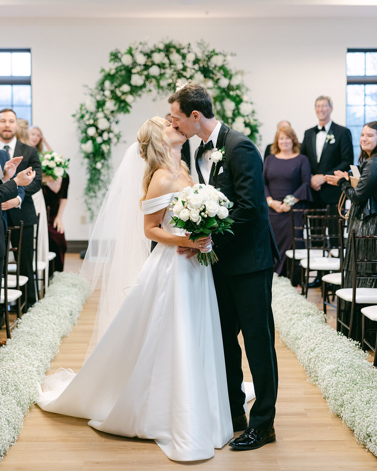 Bride and Groom walking down the aisle kissing shot by Philadelphia photographer.