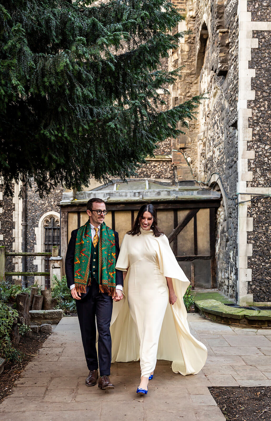 Bride and Groom walking hand in hand outside London church
