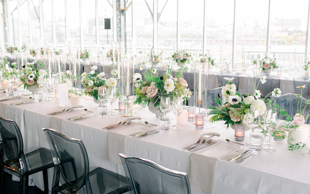 Elegant table settings and lush floral centrepieces at a wedding reception at the Science Centre. 