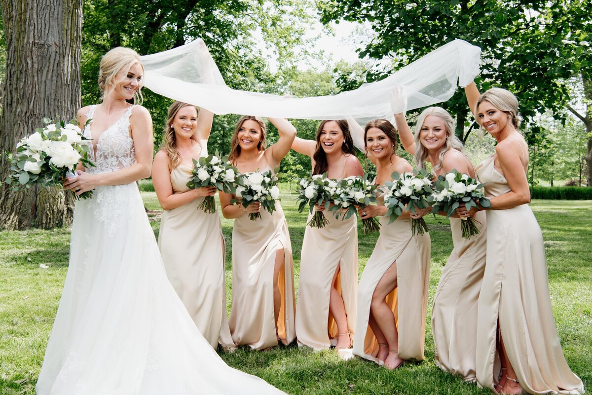 neutral bridesmaids dresses with all white wedding decor