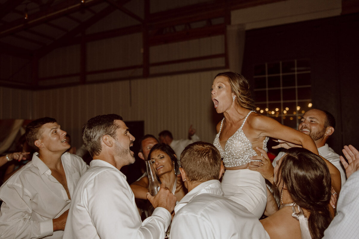 Wedding Reception Groomsmen hold Bride in the air