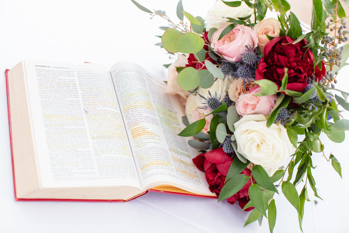 bible open with wedding bouquet of red peonies at Gardens of West Green in San Antonio Texas by Firefly Photography