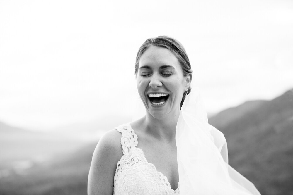 bride laughs joyfully with her eyes closed and huge smile on her face
