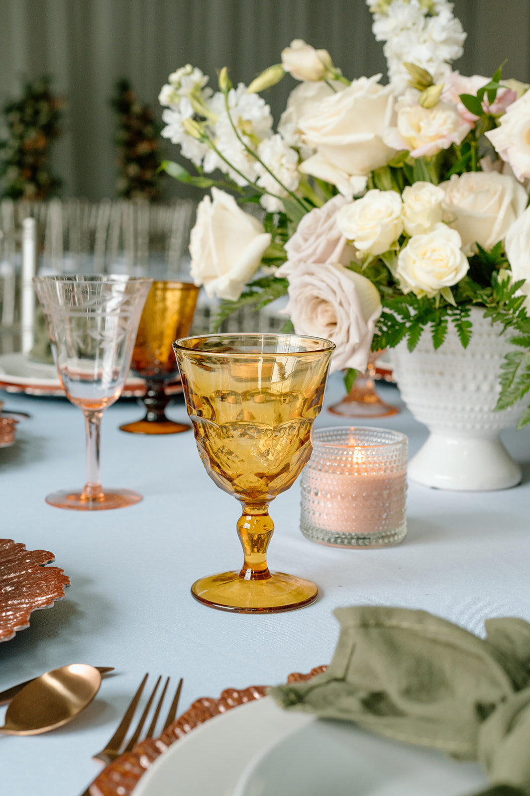 Stunning gold goblets and romantic candlelight on the wedding reception table, creating an atmosphere of timeless elegance and spiritual significance.