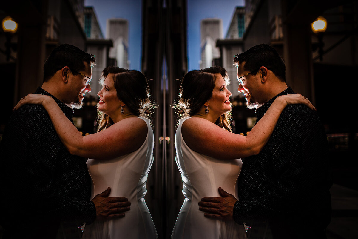 A couple hugs during a nighttime engagement session in downtown Chicago.