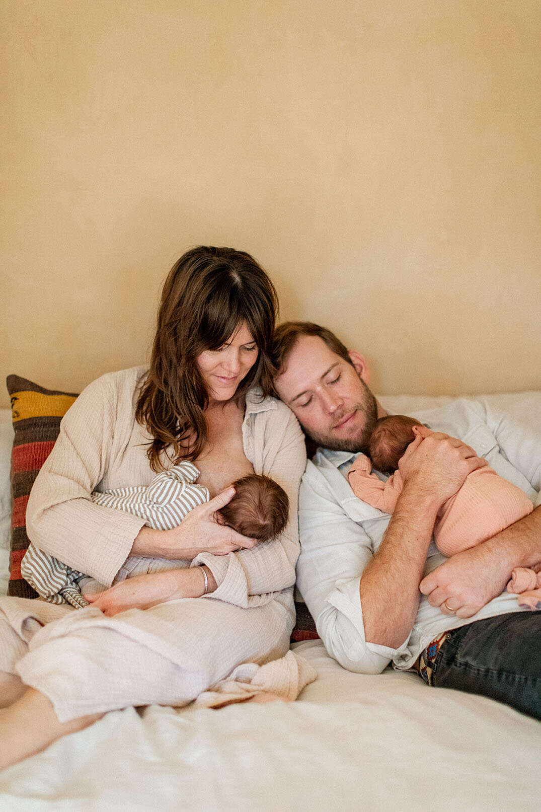 Twin babies with both parents - Sara James San Antonio photographer captures dual parenting joy and twin family portraits during specialized multiple birth sessions in comfortable Texas home environments
