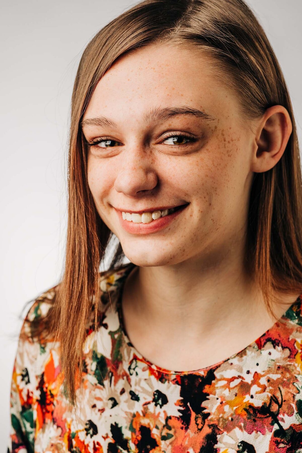 Studio headshot of Missoula girl in floral dress