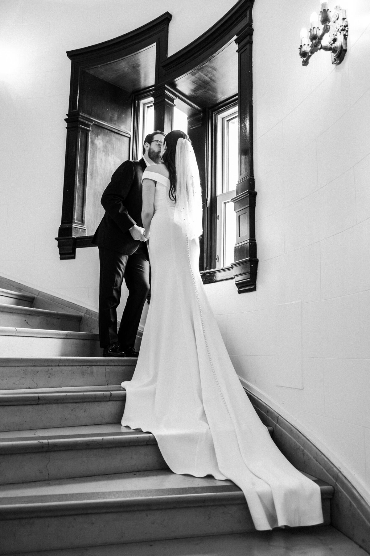 Couple standing together in the staircase of Chateau Laurier in Ottawa